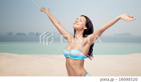 happy woman in bikini swimsuit with raised hands happy woman in bikini swimsuit with raised hands 16098520