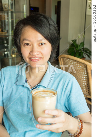 Customer enjoying hot coffee latte Customer enjoying hot coffee latte 16100362