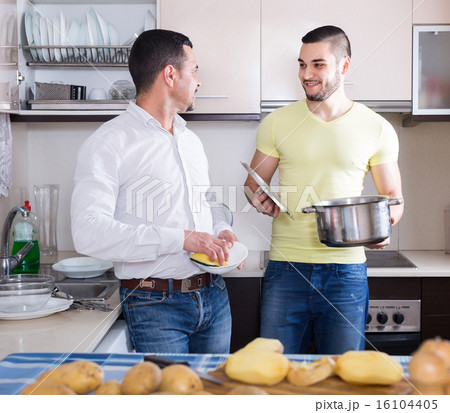 Two men cooking at home 16104405