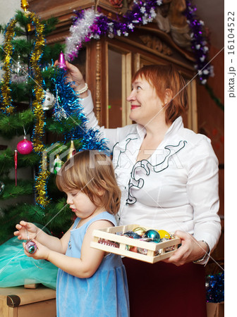 mature woman and child preparing for Christmas mature woman and child preparing for Christmas 16104522