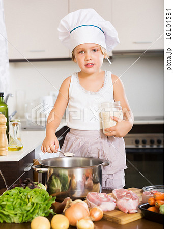 baby girl in cook hat cooking soup 16104534