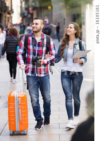 Couple with luggage walking Couple with luggage walking 16105161