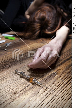Young woman poses as unconscious drug addict. 16109788