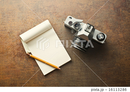 old analogue camera and notepad 16113286