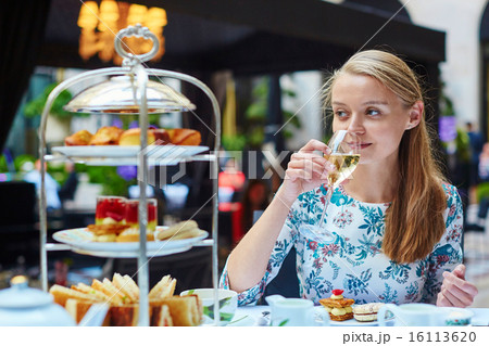 Beautiful young woman enjoying afternoon tea 16113620