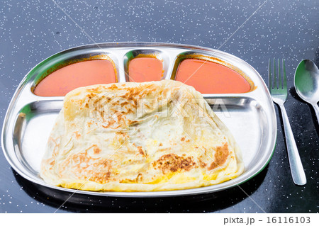 Roti Telur, or bread served with eggs with curry 16116103