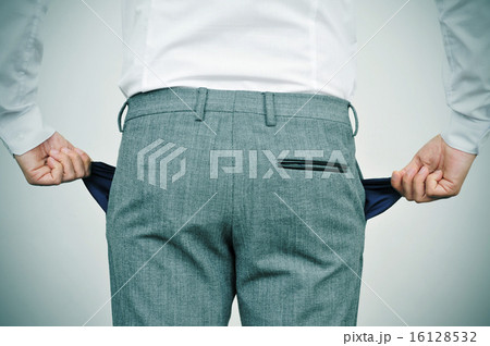 broke businessman showing his empty pockets 16128532