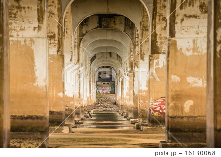 standing under old bridge over the river 16130068