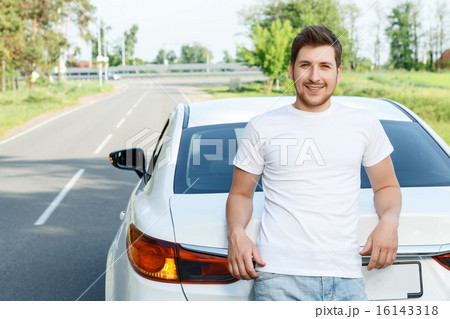 Smiling man standing near car Smiling man standing near car 16143318