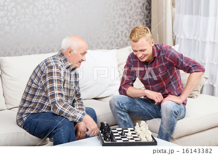 Grandfather and grandson playing chess Grandfather and grandson playing chess 16143382