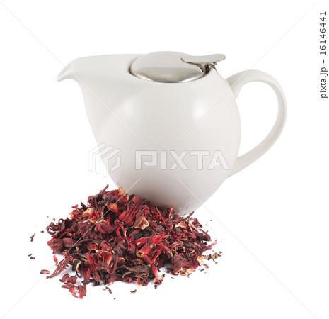 Ceramic teapot next to pile of tea isolated 16146441