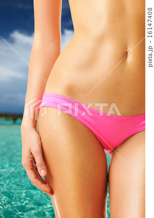 Woman on beautiful beach with jetty 16147408