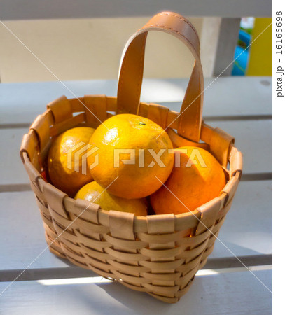 Oranges in the basket on white chair. Oranges in the basket on white chair. 16165698