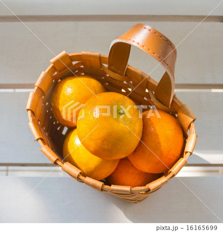 Oranges in the basket on white chair. 16165699