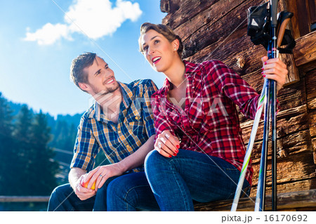 Couple resting from walking in mountain cabin 16170692