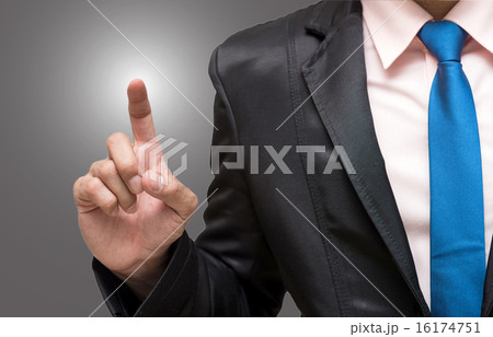 Businessman pointing or touching on gray background 16174751