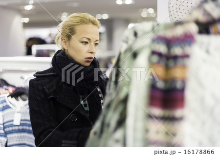 Beautiful woman shopping in clothing store. Beautiful woman shopping in clothing store. 16178866