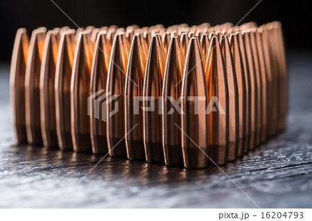 Macro shot of copper bullets that are in many rows to form a tri Macro shot of copper bullets that are in many rows to form a tri 16204793