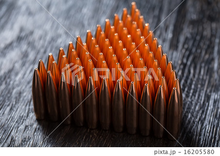 Macro shot of copper bullets that are in many rows to form a tri Macro shot of copper bullets that are in many rows to form a tri 16205580