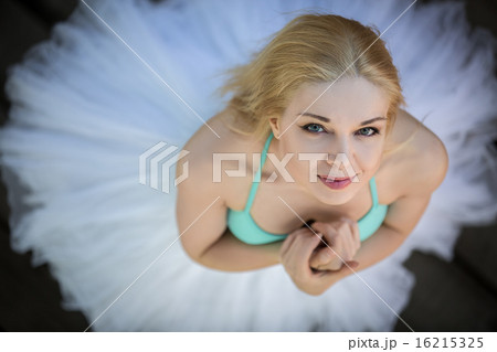 Close portrait of a cute ballerina in white tutu and blue bathin Close portrait of a cute ballerina in white tutu and blue bathin 16215325