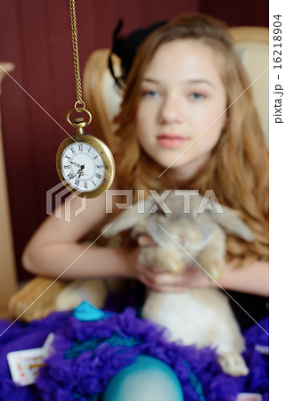 Young girl at the image of Alice in Wonderland Young girl at the image of Alice in Wonderland 16218904