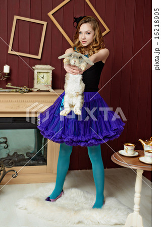 Young girl at the image of Alice in Wonderland Young girl at the image of Alice in Wonderland 16218905