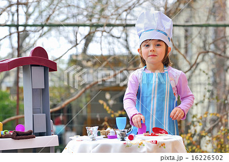 Little girl having fun playing cooking 16226502