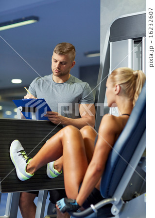 man and woman flexing muscles on gym machine 16232607