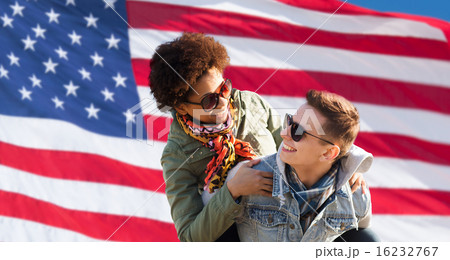 happy multiracial couple over american flag 16232767