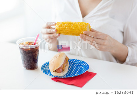 woman hands holding corn with hot dog and cola woman hands holding corn with hot dog and cola 16233041