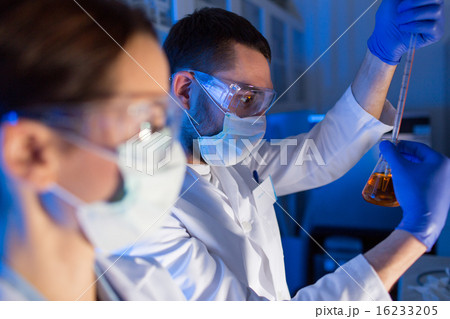 close up of scientists making test in lab 16233205