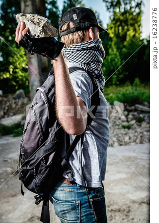 Man holding big stone in a hand 16238776