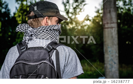 Man covering face with a scarf 16238777