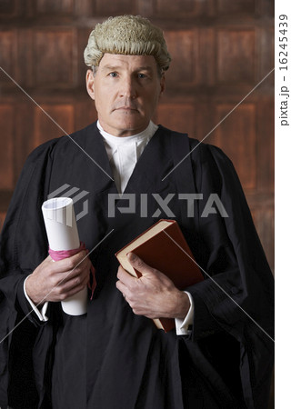 Portrait Of Male Lawyer In Court Holding Brief And Book 16245439