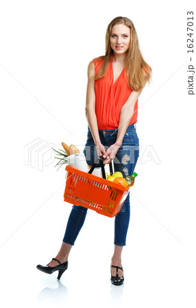 Happy woman holding a basket full of healthy food 16247013