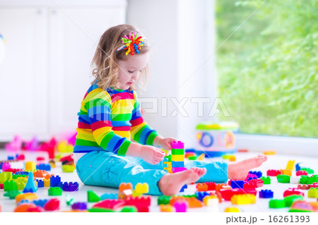 Little girl playing with colorful toy blocks 16261393