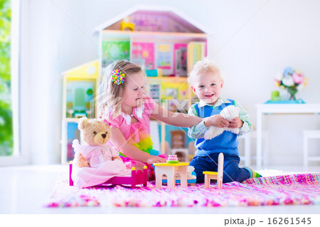 Kids playing with stuffed animals and doll house Kids playing with stuffed animals and doll house 16261545