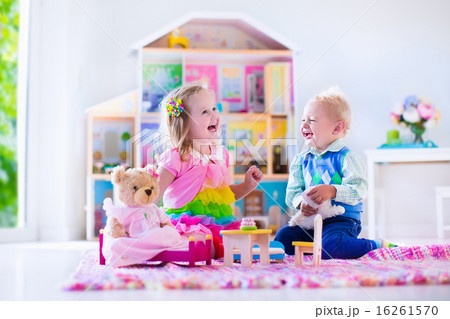 Kids playing with stuffed animals and doll house 16261570