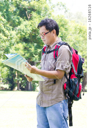 Asian man backpacker with map in hand. Asian man backpacker with map in hand. 16268516