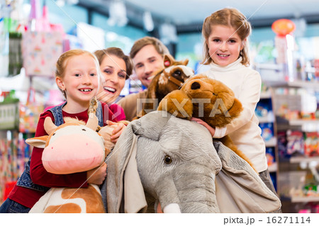 Family with stuffed elephant in toy store playing Family with stuffed elephant in toy store playing 16271114