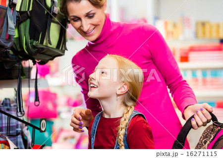 Family buying school satchel or bag in store 16271115