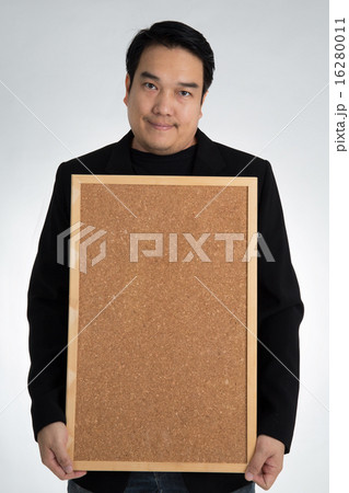 Asian man in black suit holds an empty woodboard Asian man in black suit holds an empty woodboard 16280011