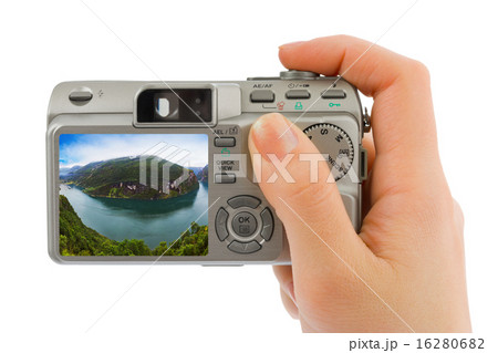 Hand with camera and Norway travel photo 16280682