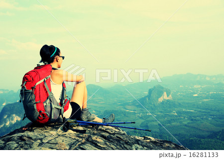woman hiker enjoy the view at sunset mountain peak 16281133