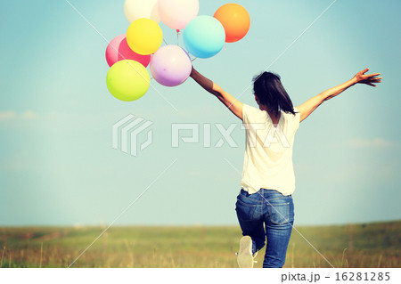 young asian woman with colored balloons young asian woman with colored balloons 16281285