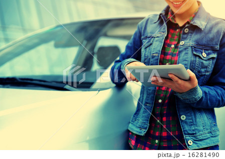 woman use digital tablet leaning on car 16281490