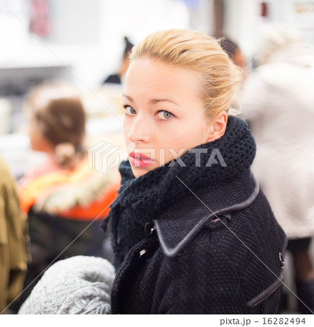 Female shopper queuing in line at cashier. Female shopper queuing in line at cashier. 16282494