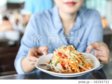 Woman holding a Thai papaya salad with horse crab 16283732
