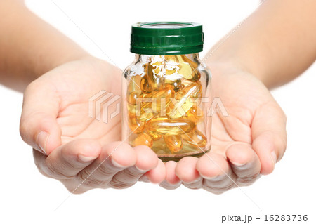 Hand holding a fish oil vitamin in white backgroun 16283736