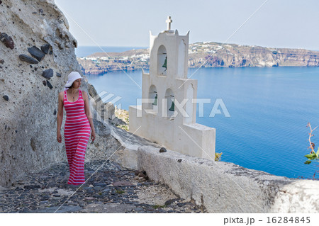 Woman walks up the mountain stairs. Greece Santorini 16284845